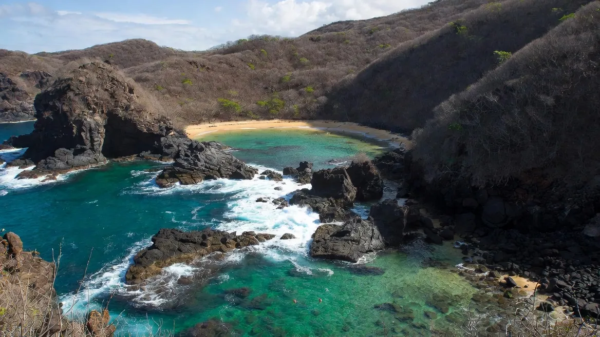 Rocky coves and beaches strung along the Puerto Escondido coast, from calm swimming bays to open surf